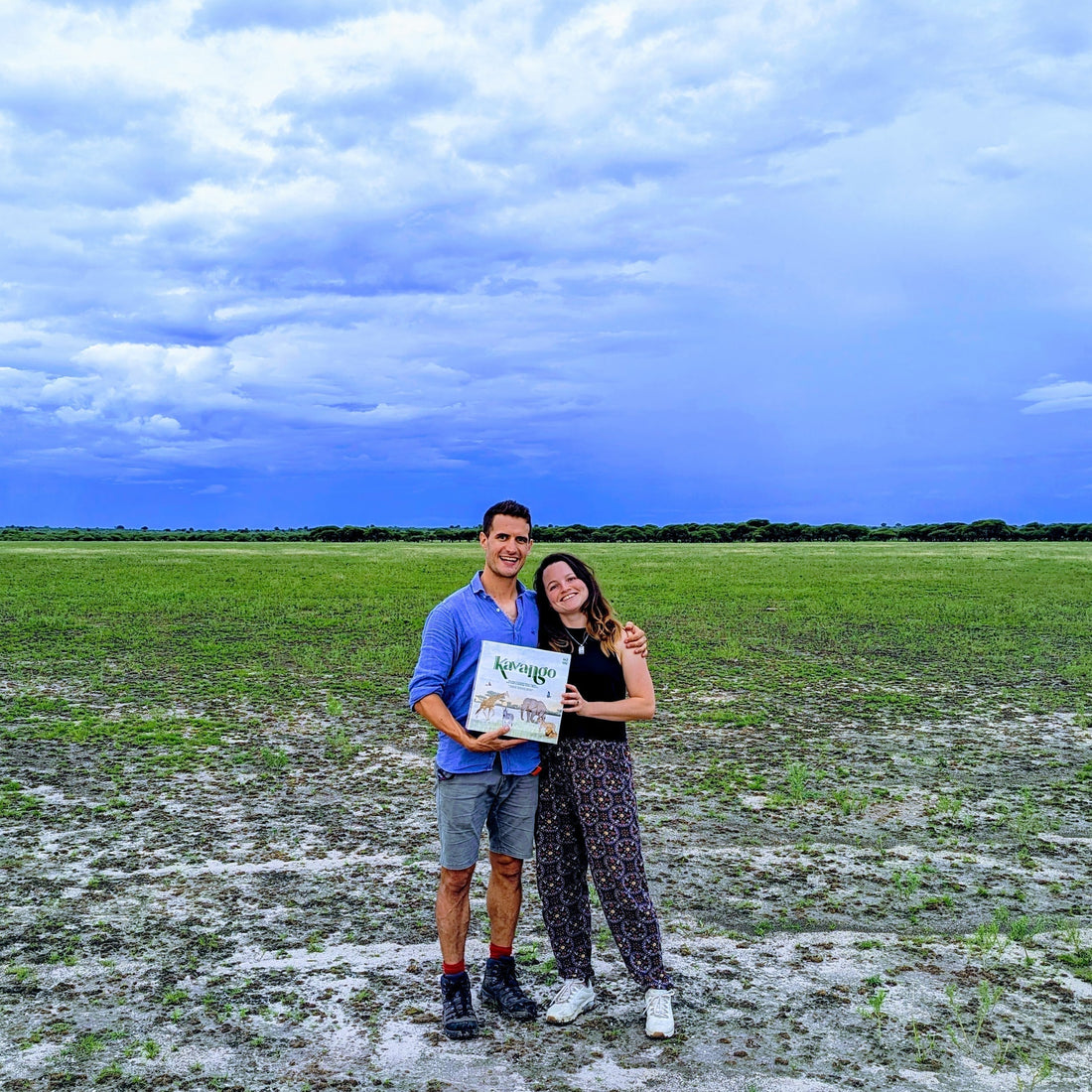 Matt and Zara holding the first prototype of Kavango in the Kalahari in 2023