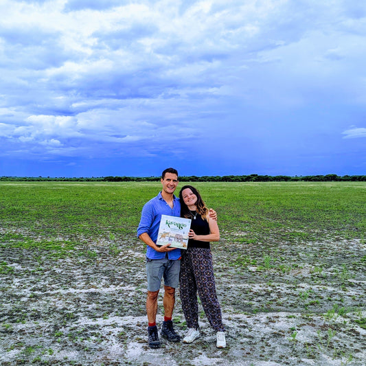 Matt and Zara holding the first prototype of Kavango in the Kalahari in 2023